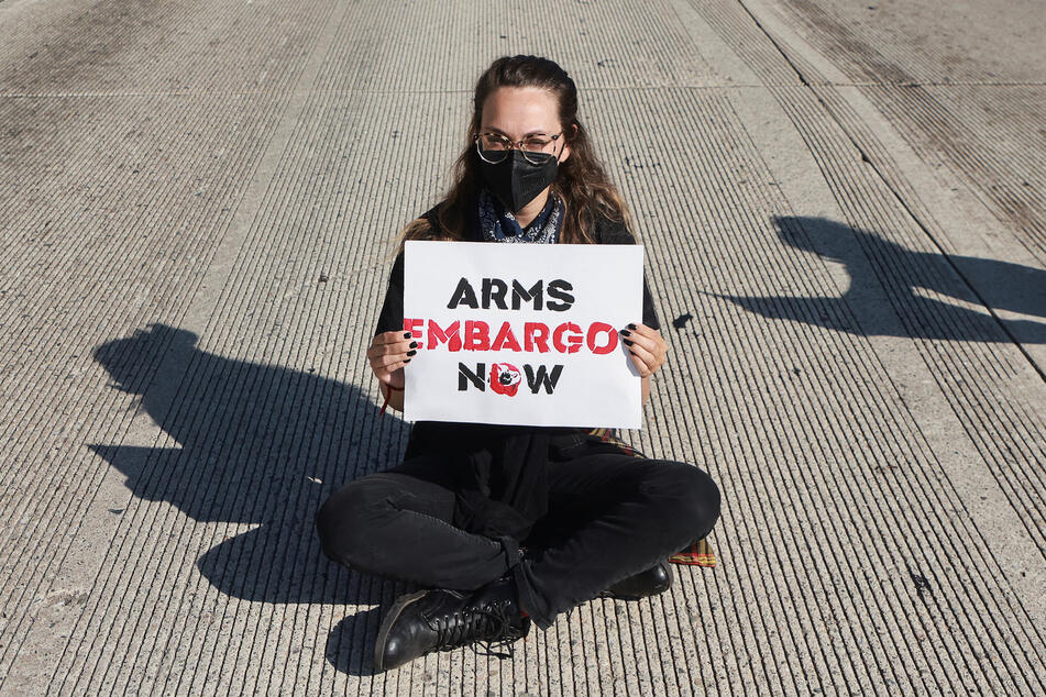 A protester blocks the 405 freeway's southbound lanes in Los Angeles, California, to demand an arms embargo on Israel.