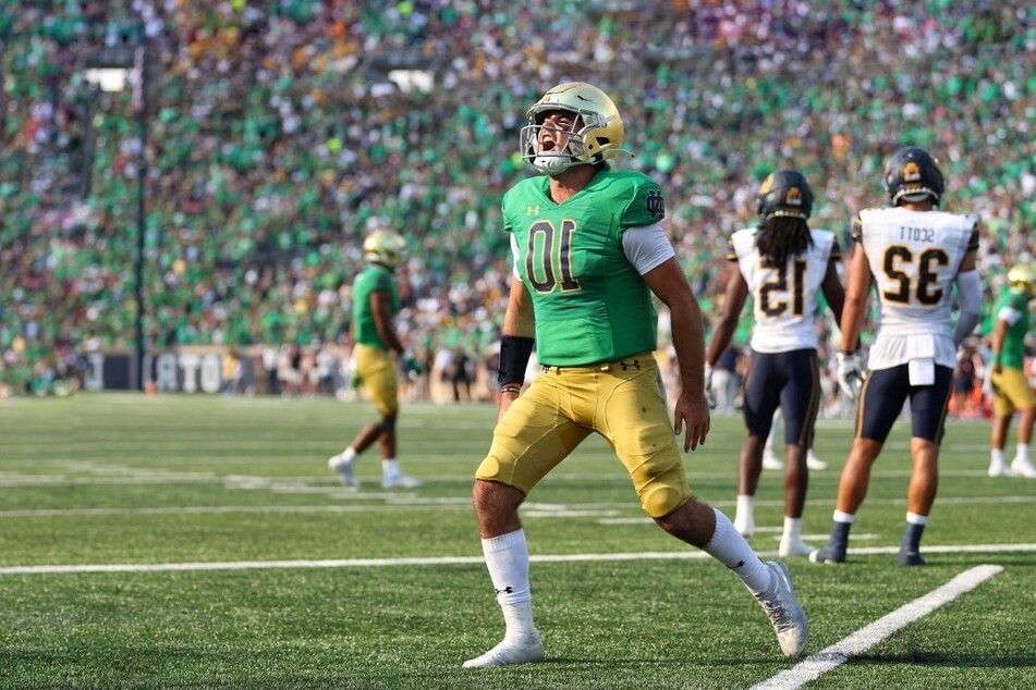 Drew Pyne of the Notre Dame Fighting Irish celebrates after throwing a touchdown pass to Michael Mayer against the California Golden Bears during the second half at Notre Dame Stadium.