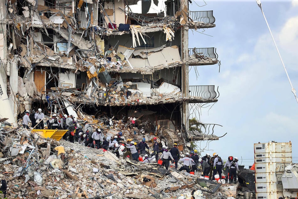 The death toll has risen to at least 12 in the Surfside building collapse.