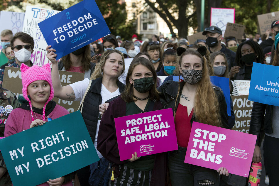 Coloradans march outside the State Capitol demanding reproductive freedom.