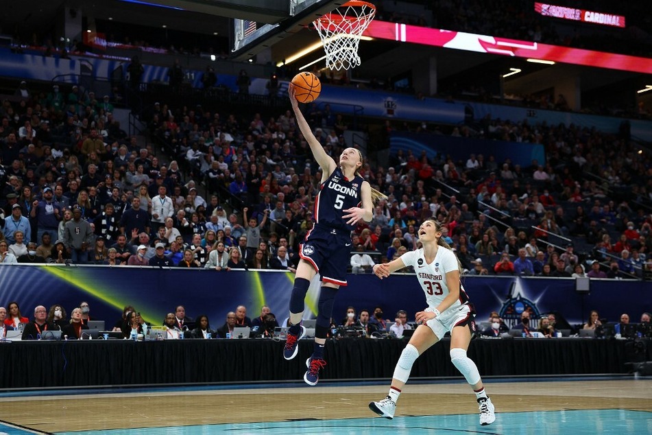 Paige Bueckers of the UConn Huskies lays the ball against the Stanford Cardinals in the during the 2022 NCAA Women's Final Four.