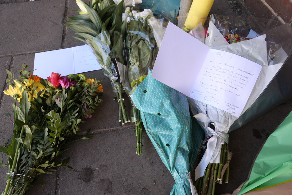 Blumen liegen an der Kreuzung von Cloister Court und Church Street, wo ein Mann bei dem Angriff mit einem Auto ums Leben gekommen ist.