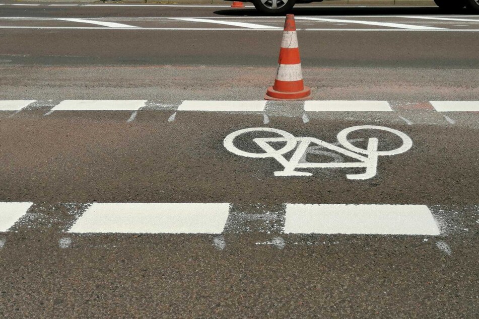 Mit Heißplastik werden die Radfahrstreifen markiert.