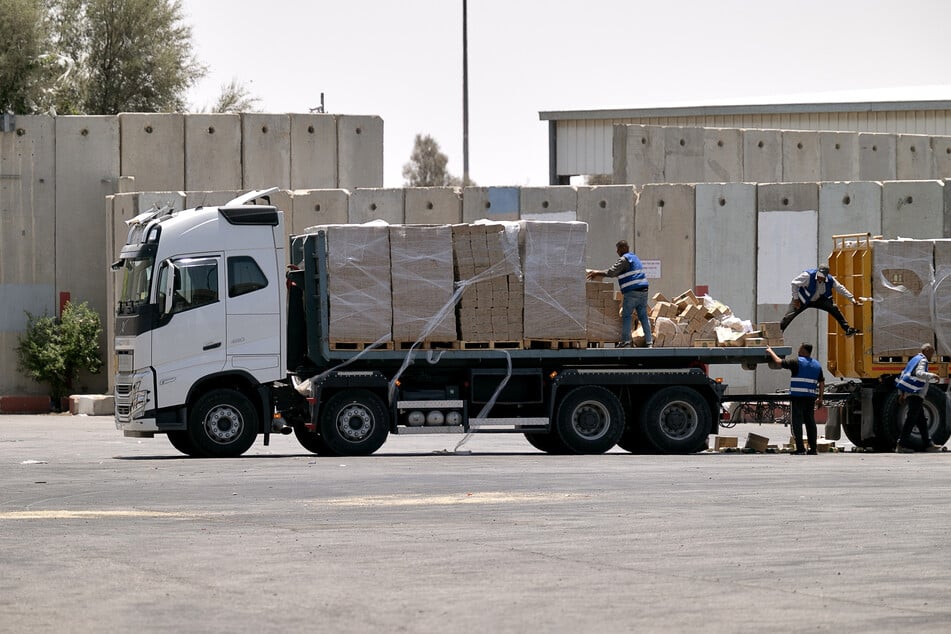 A truck carrying humanitarian aid for the Gaza Strip is loaded at the Kerem Shalom border crossing between southern Israel and Gaza, on June 17, 2024.