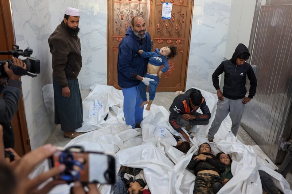 Relatives mourn over the bodies of children killed an Israeli strike that targeted an area in Khan Younis on the southern Gaza Strip on October 25, 2024.