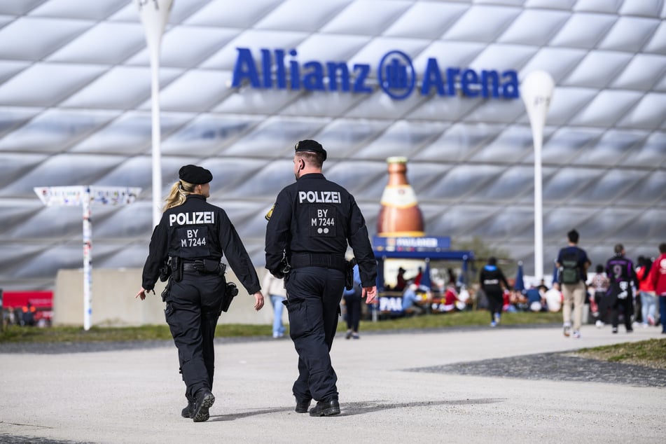 Polizisten patrouillieren vor der Allianz-Arena in München.