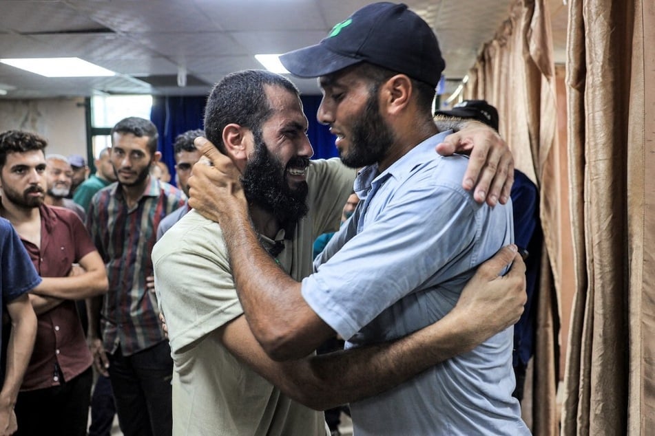 A Palestinian man detained by Israel during the military operation in Rafah reacts as he embraces his brother after his release at the Aqsa Martyrs Hospital in Deir el-Balah.