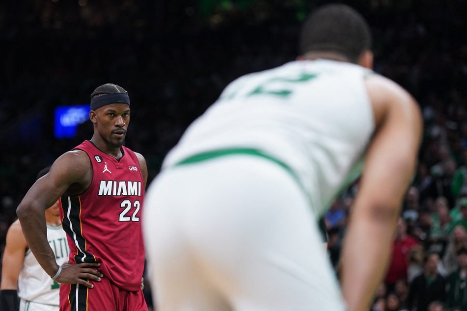 Butler scored nine of his 27 points after a heated exchange with Boston's Grant Williams (r.).