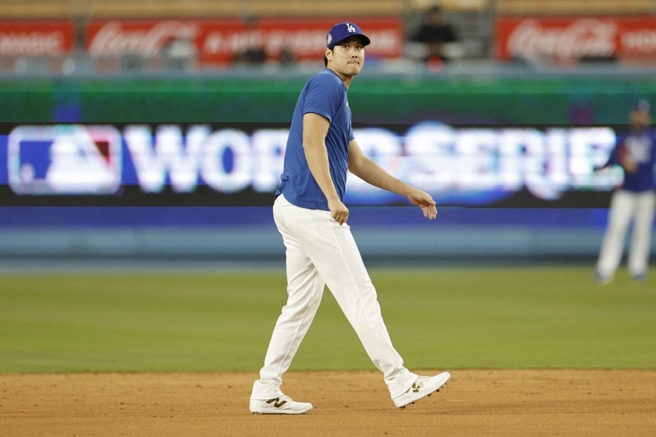 Shohei Ohtani of the Los Angeles Dodgers warms up during a workout day ahead of Game 1 of the 2024 World Series at Dodger Stadium.