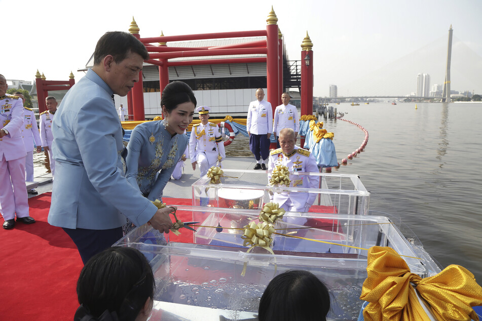 Maha Vajiralongkorn (vorne) und seine Geliebte lassen während einer Zeremonie zu ihrem 36. Geburtstag Fische in den Chao Phraya Fluss.