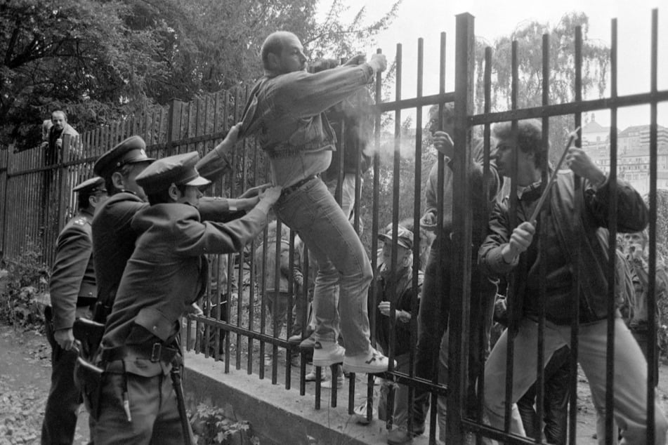 Dramatisch: Tschechoslowakische Polizisten beim Versuch, einen DDR-Bürger im September 1989 vom Klettern über den Zaun abzuhalten.