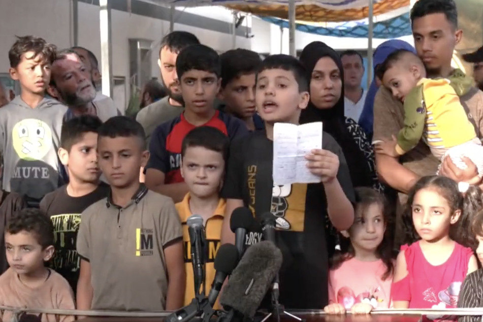 Children in Gaza hold a press conference outside the Al-Shifa Hospital calling for protection from Israel's ongoing assault.