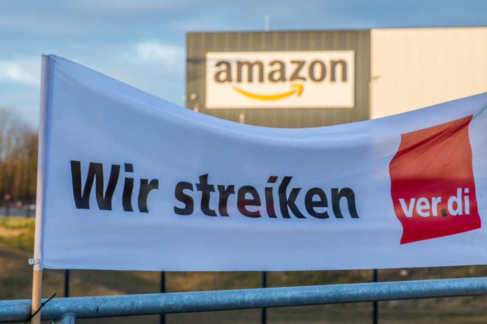 Das Foto aus dem März dieses Jahres zeigt ein Verdi-Banner mit der Aufschrift: "Wir streiken" vor einem Amazon-Logistik-Zentrum.