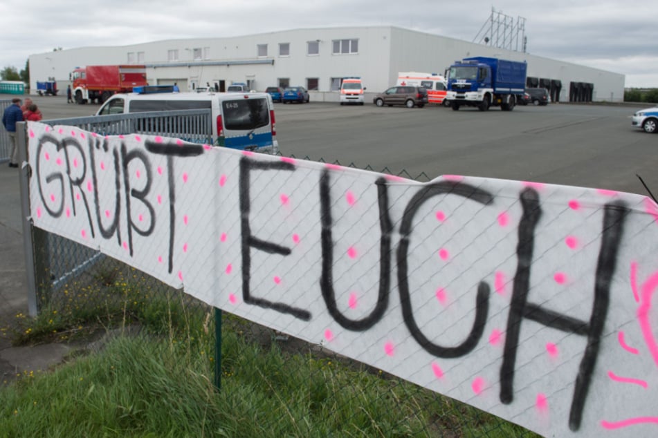Ein Banner mit der Aufschrift "Grüßt euch" hängt vor einer Flüchtlingsunterkunft.