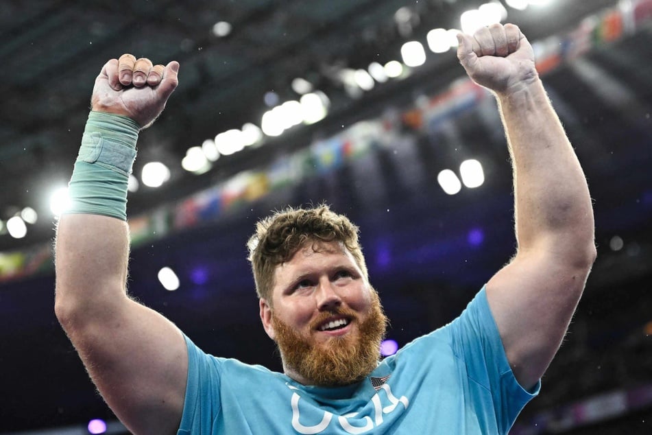 Gold medallist US' Ryan Crouser celebrates after the men's shot put final of the athletics event at the Paris 2024 Olympic Games at Stade de France in Saint-Denis, north of Paris, on Saturday.