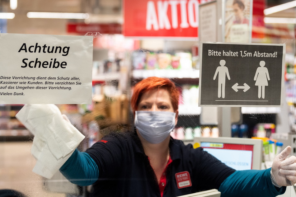 Eine Supermarkt-Mitarbeiterin desinfiziert ihren Arbeitsplatz. Die Gewerkschaft will für den Handel einen Mindeststundenlohn von 12,50 Euro erkämpfen.