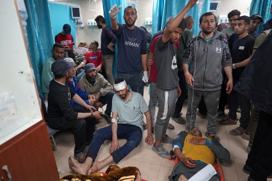 Injured Palestinian men lie on the floor at the Al-Aqsa Martyrs Hospital in Deir al-Balah in the central Gaza Strip, following Israel bombardment on March 31, 2024.