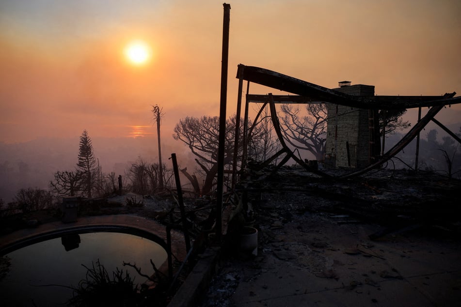 The remains of a house burned down by the Palisades Fire are pictured in the Pacific Palisades neighborhood in Los Angeles, California, on January 9, 2025.