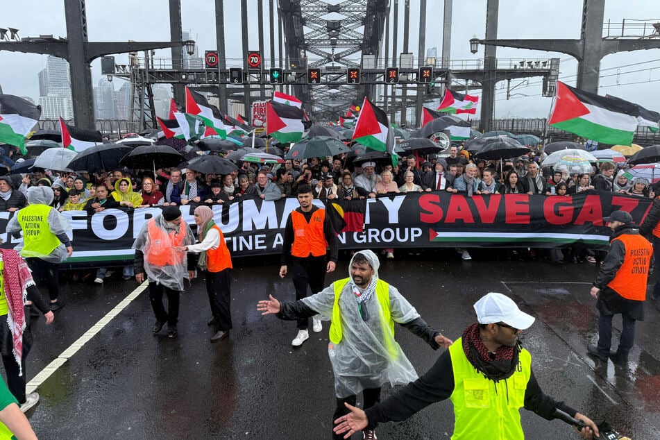 Protesters walk across the Sydney Harbour Bridge during the Palestine Action Group's March for Humanity in Australia on August 3, 2025.