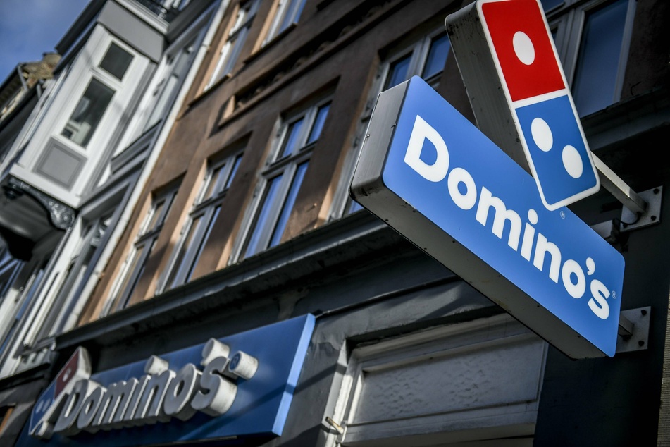 Domino's is rolling with the punches and taking on new technology to beef up customer service and efficiency. A storefront in Copenhagen showed one of many worldwide locations.
