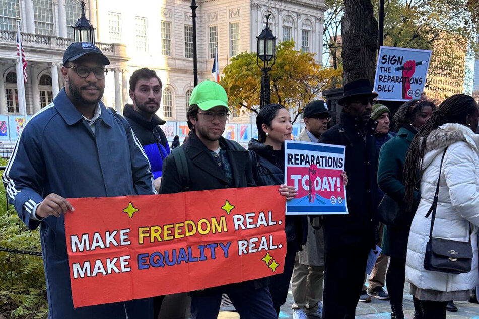 Activists with the Get Free Movement rally in front of New York City Hall calling for Governor Kathy Hochul to sign a bill to create a state reparations commission.