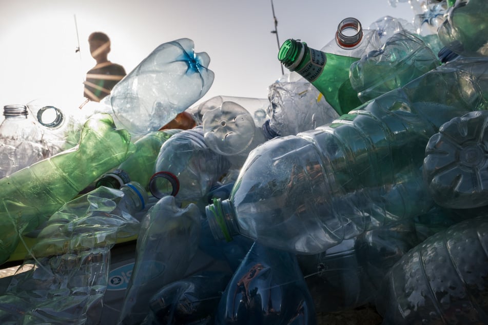 A boy walks past an artwork by Canadian artist, activist, and photographer Benjamin Von Wong entitled The Thinker's Burden, a sculptural remix of Rodin's iconic Thinker, which is being created for the Plastics Treaty Negotiations at the United Nations Offices in Geneva.