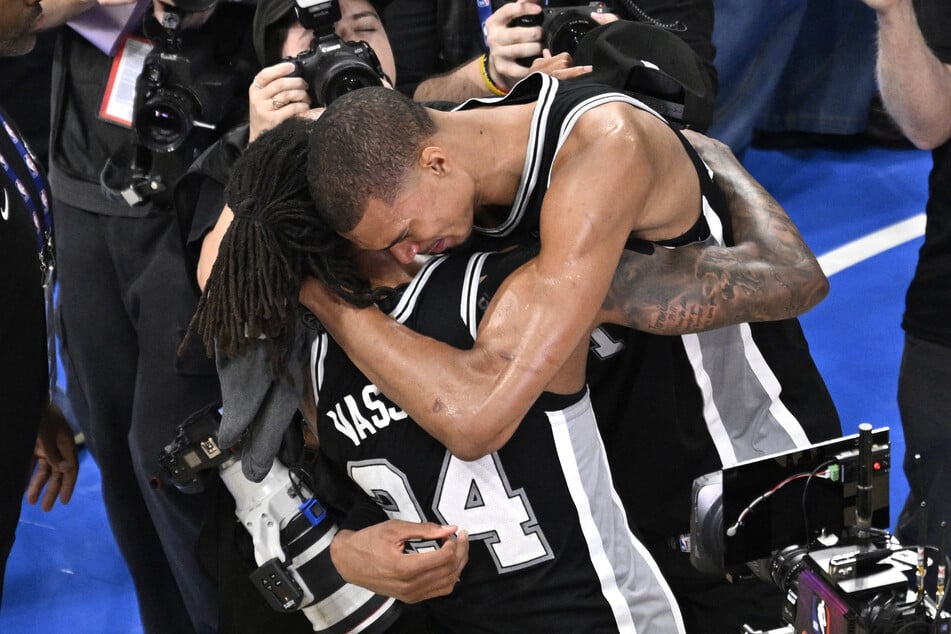 San Antonio Spurs forward Victor Wembanyama (r.) celebrates with guard Devin Vassell after defeating the Oklahoma City Thunder in game seven of the Western Conference Finals.