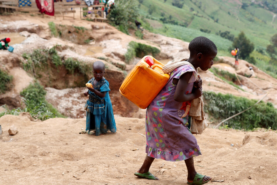A girl carries a container of water at a coltan mine in Kamatare, Masisi territory, North Kivu Province of Democratic Republic of Congo.