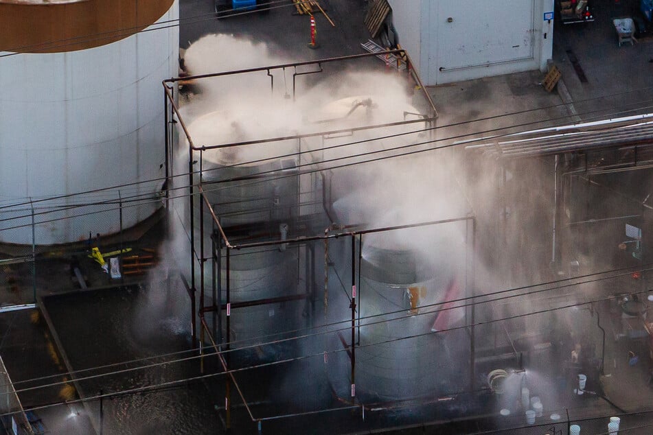 An aerial view of water being sprayed onto an overheated 34,000-gallon tank at GKN Aerospace on Saturday in Garden Grove, California.
