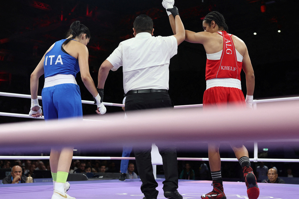 Imane Khelif of Algeria (r.) is declared the winner after her fight with Angela Carini of Italy at the Paris Olympics.