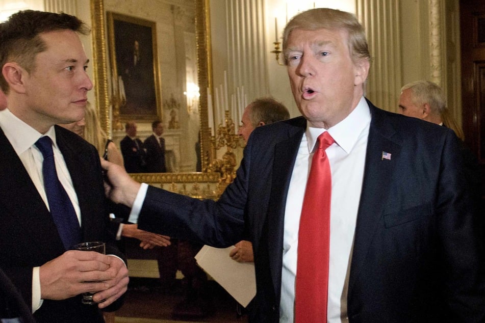 Then-US President Donald Trump (r.) greets Elon Musk (l.), SpaceX and Tesla CEO, before a policy and strategy forum with executives in the State Dining Room of the White House February 3, 2017 in Washington, DC.