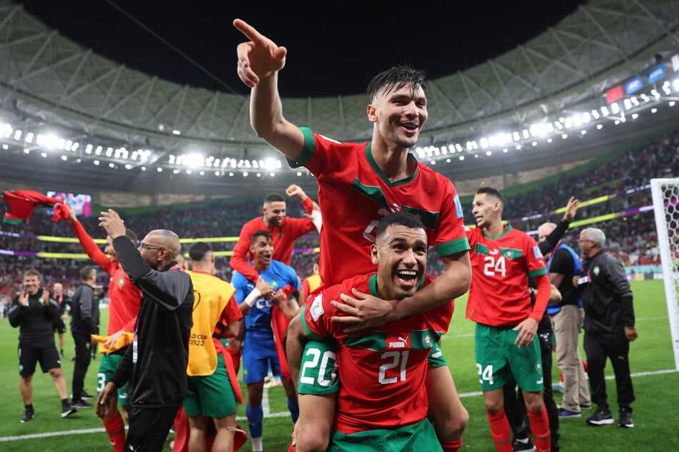 Morocco's Achraf Dari and Morocco's Walid Cheddira celebrate after the match as Morocco progress to the semi-finals.