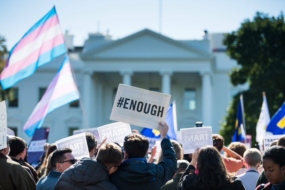 LGBTQ+ rights activists gather in protest in front of the White House during the Trump administration.