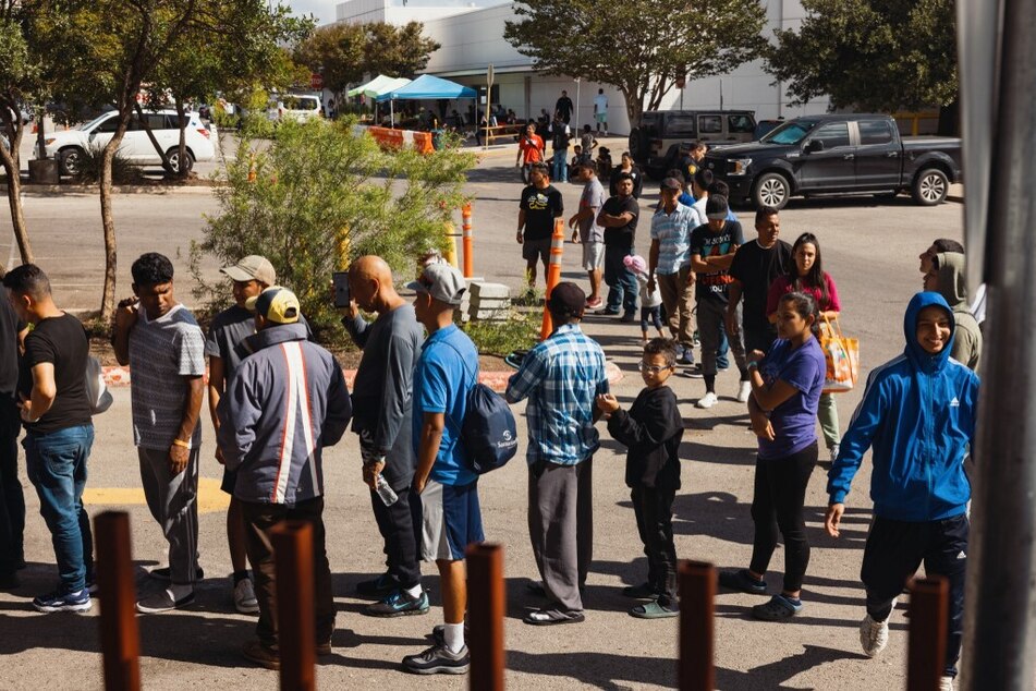 Groups of migrants wait to receive food outside the Migrant Resource Center in San Antonio, Texas, where the flights were boarded to Martha's Vineyard.