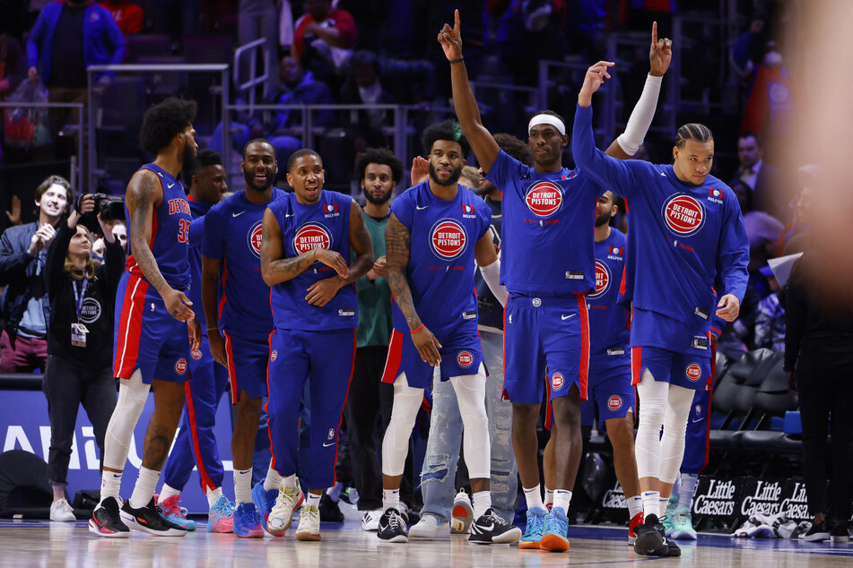 Detroit Pistons players celebrate after defeating the Dallas Mavericks at Little Caesars Arena.