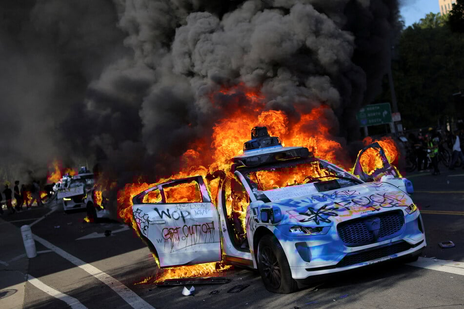 LA protesters torched Waymos and face off with militarized police as the Trump administration's response to mass uprisings inflamed tensions.