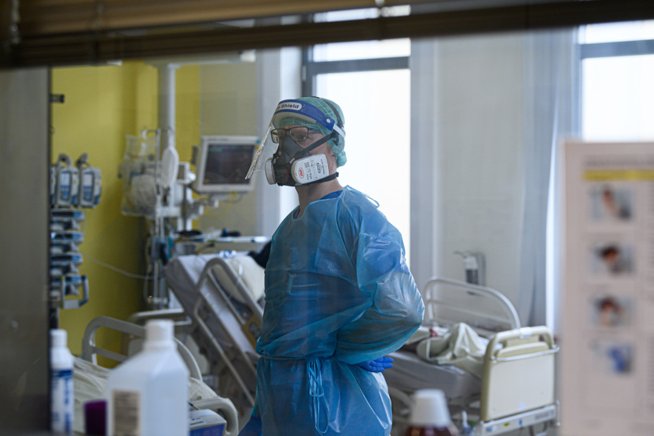 Ein Intensivpfleger ist auf der Covid-19 Intensivstation (ITS) im Städtischen Klinikum Dresden mit der Versorgung von Corona-Patienten beschäftigt.