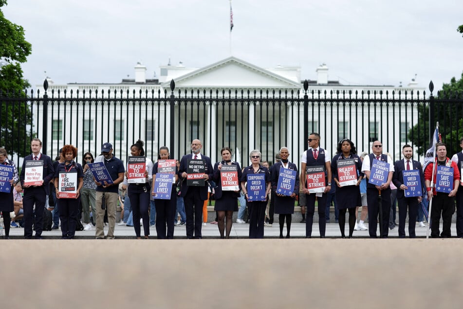 Dozens of American Airlines flight attendants demonstrated Thursday in front of the White House as they seek to be allowed to strike during protracted contract negotiations.