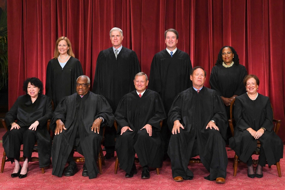 Justices of the US Supreme Court pose for their official photo at the Supreme Court, including Clarence Thomas (bottom, second from l.).