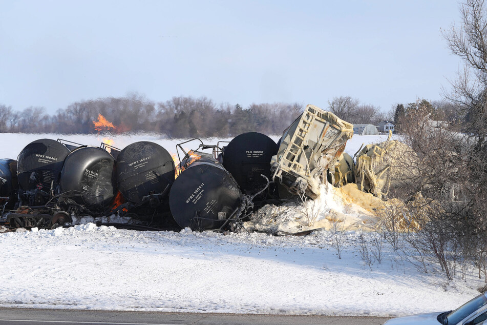 A train carrying flammable and hazardous material, including ethanol, derailed near a small town in Minnesota on Thursday, causing residents to evacuate.