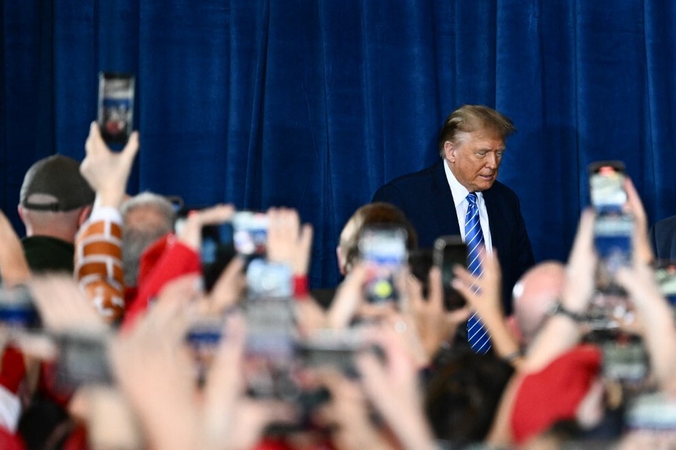 Former president and 2024 GOP hopeful Donald Trump arrives on stage to speak at a Commit to Caucus Rally in Las Vegas, Nevada, on January 27, 2024.