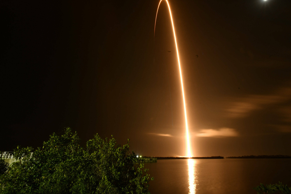 A SpaceX Falcon 9 rocket as it launches a Cargo Dragon-2 spacecraft for NASA on a NASA resupply mission.