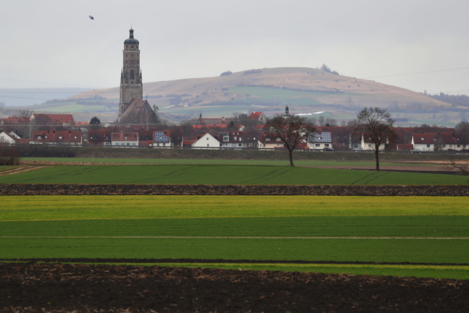 Der Glockenturm "Daniel" der Kirche Sankt Georg ragt aus der Ortsmitte der im Meteoritenkrater Nördlinger Ries liegenden Stadt.