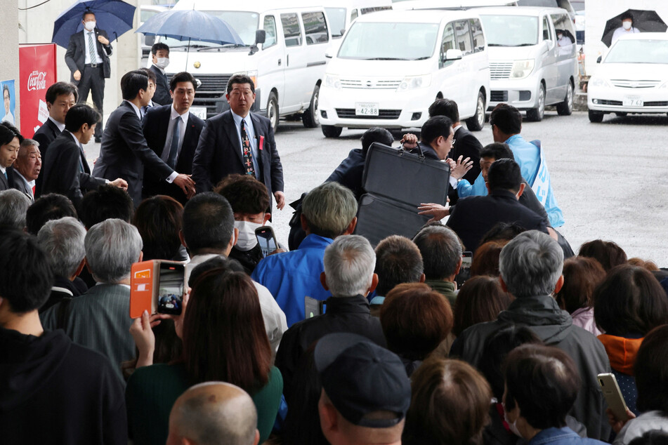 Japanese prime minister rushed to safety after smoke bomb attack