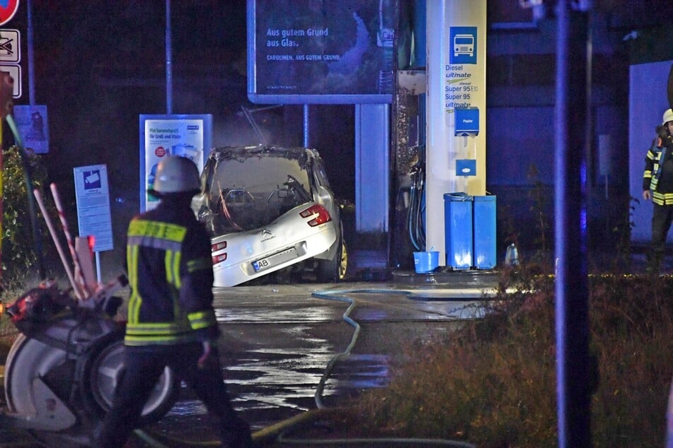 Das ausgebrannte Autowrack steht an einer Tankstelle in Gütersloh.