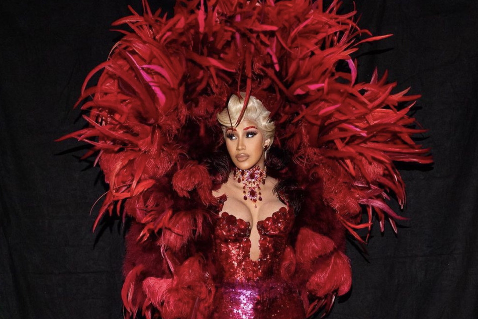 Cardi B stuns in an all red Mugler designer outfit at Paris Fashion Week.