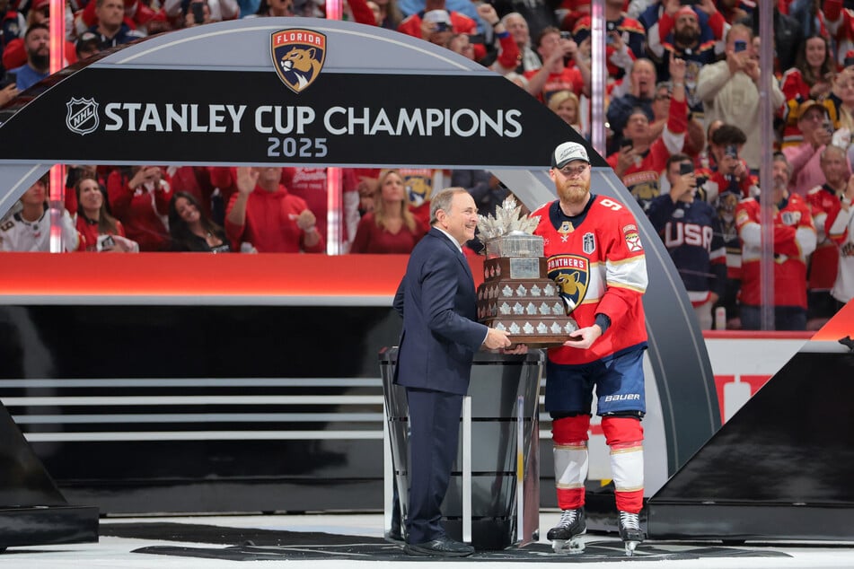 NHL Commissioner Gary Bettman (l.) presents Florida Panthers center Sam Bennett the Conn Smythe Trophy after winning game six of the 2025 Stanley Cup Final against the Edmonton Oilers at Amerant Bank Arena.