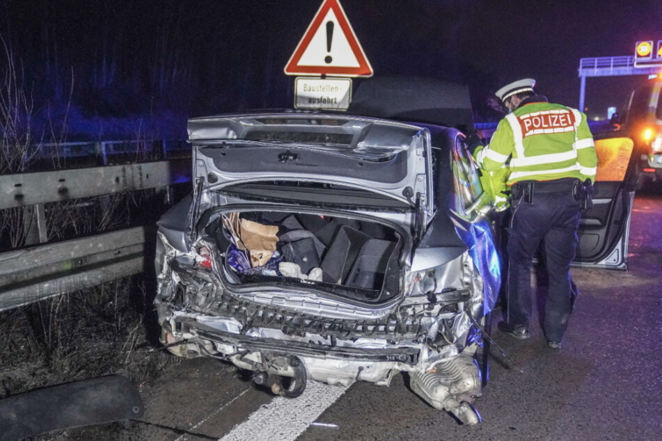 Polizisten stehen nach einem Unfall mit zwei schwer verletzten Menschen auf der Autobahn 8 bei Wendlingen am Neckar (Kreis Esslingen) neben einem Autowrack. Die Fahrbahn in Richtung München ist nach dem Unfall voll gesperrt.