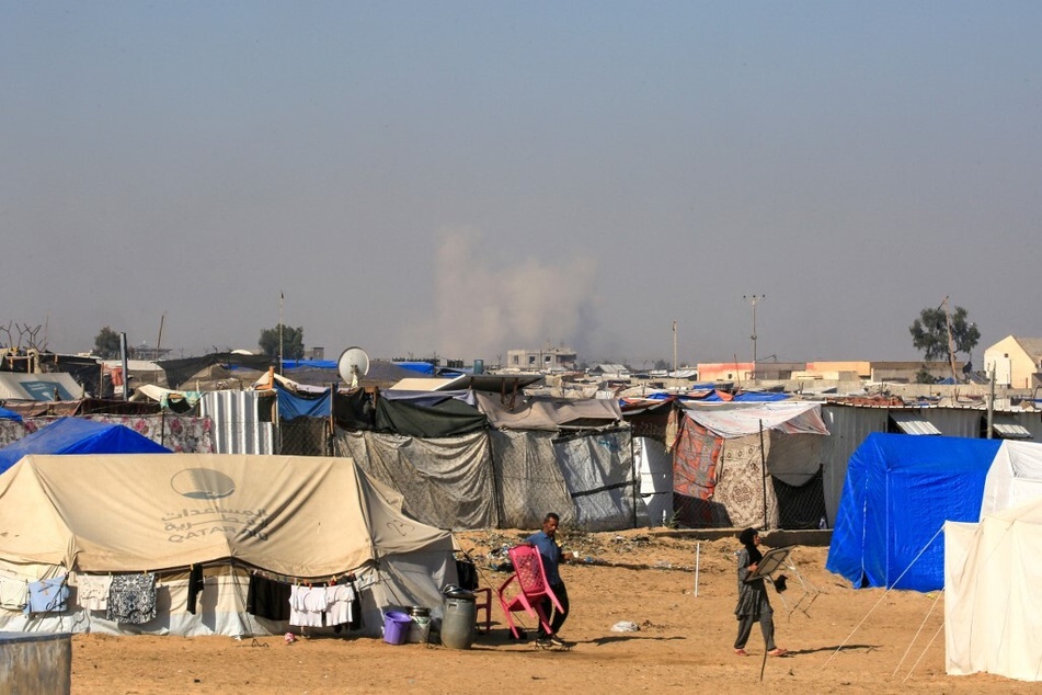 Smoke from Israeli bombardment billows in Rafah, as seen from a camp for displaced Palestinian people in Khan Younis in the southern Gaza Strip.
