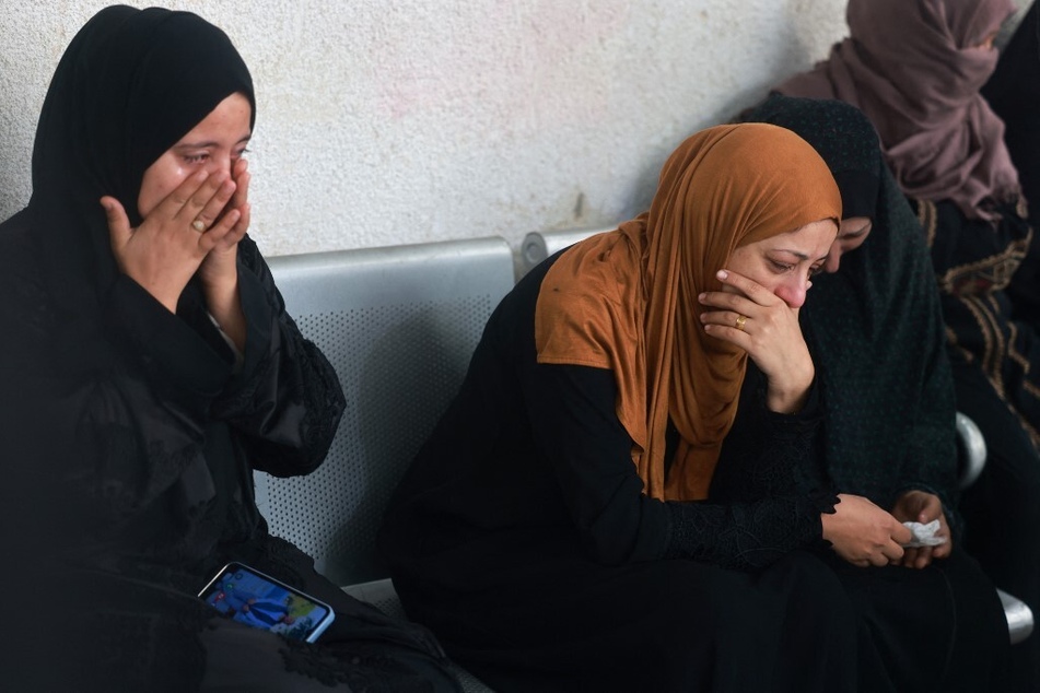 Palestinians mourn relatives killed in Israeli bombardment, at the al-Najjar hospital in Rafah in the southern Gaza Strip.